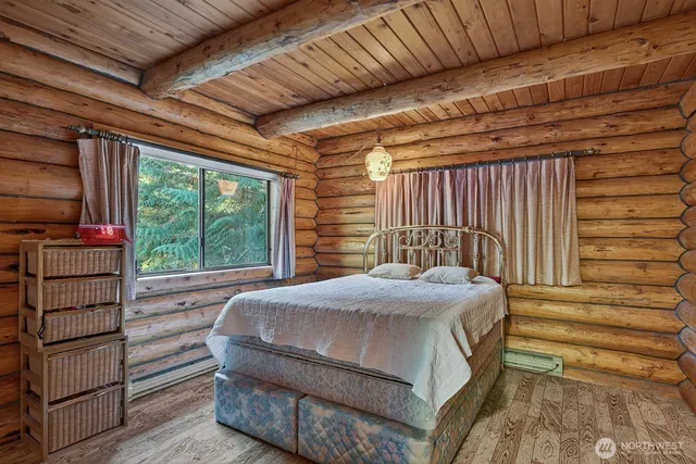 a bed sitting in a bedroom next to a window