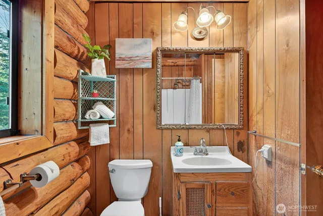 a bathroom with a sink and mirror with toilet