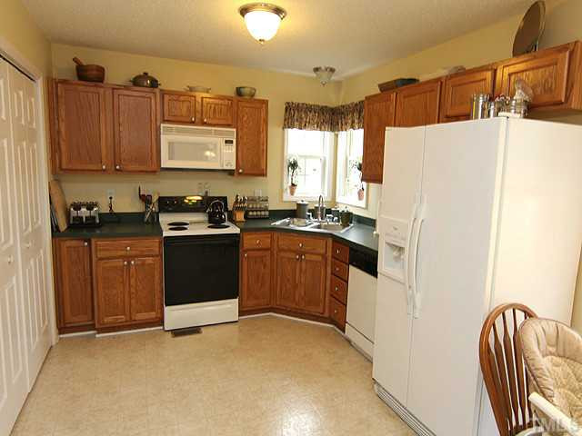 28 Round Spring Lane Durham, NC 27712 - Photo 5 of 12 LARGE KITCHEN HAS NICE CORNER WINDOWS OVERLOOKING BACKYARD. ALL APPLIANCES CONVEY TOO! Kitchen