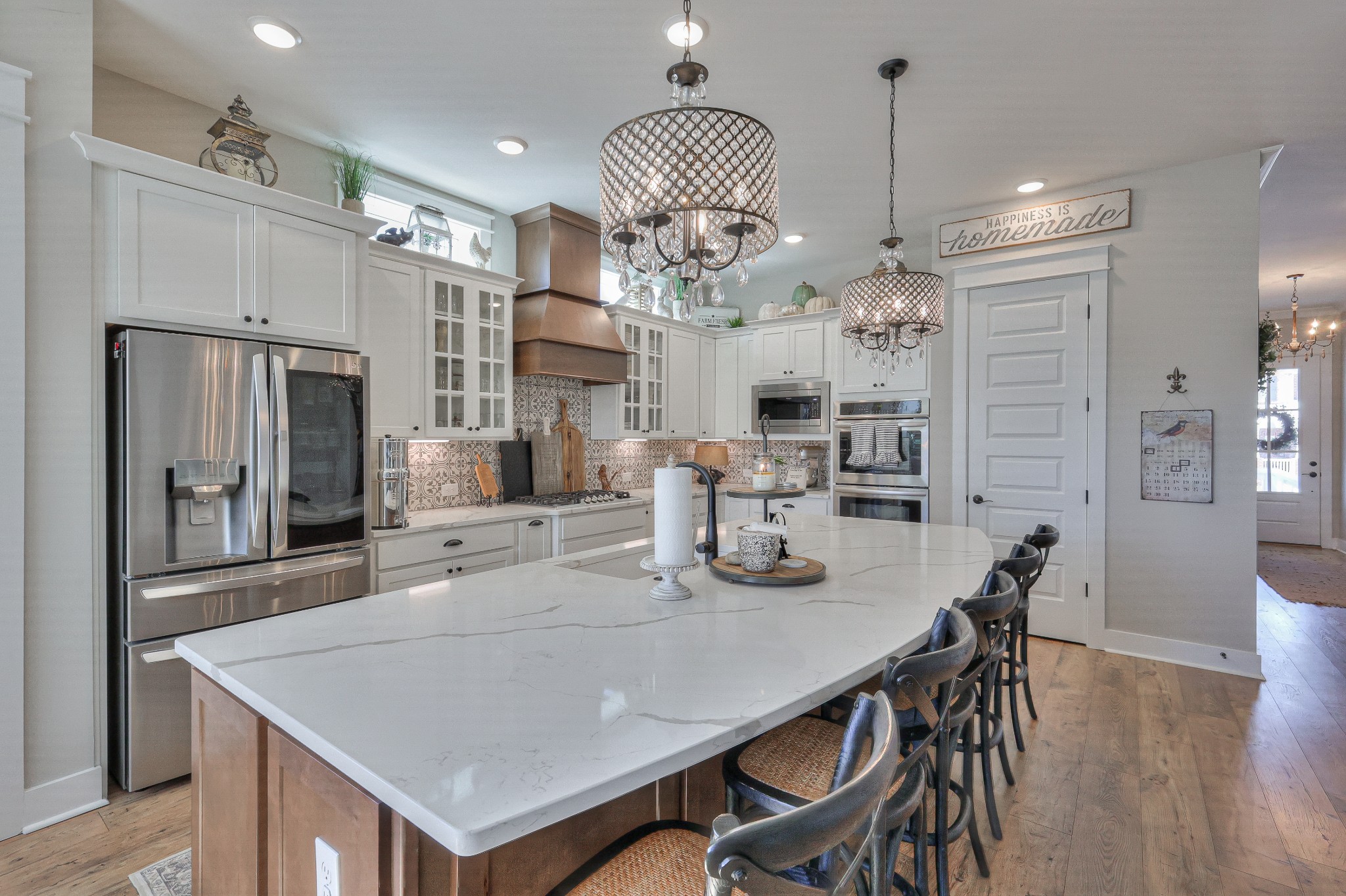 7760 Thayer Road Nolensville, TN 37135 - Photo 11 of 58 a large kitchen with granite countertop a table chairs stainless steel appliances and cabinets