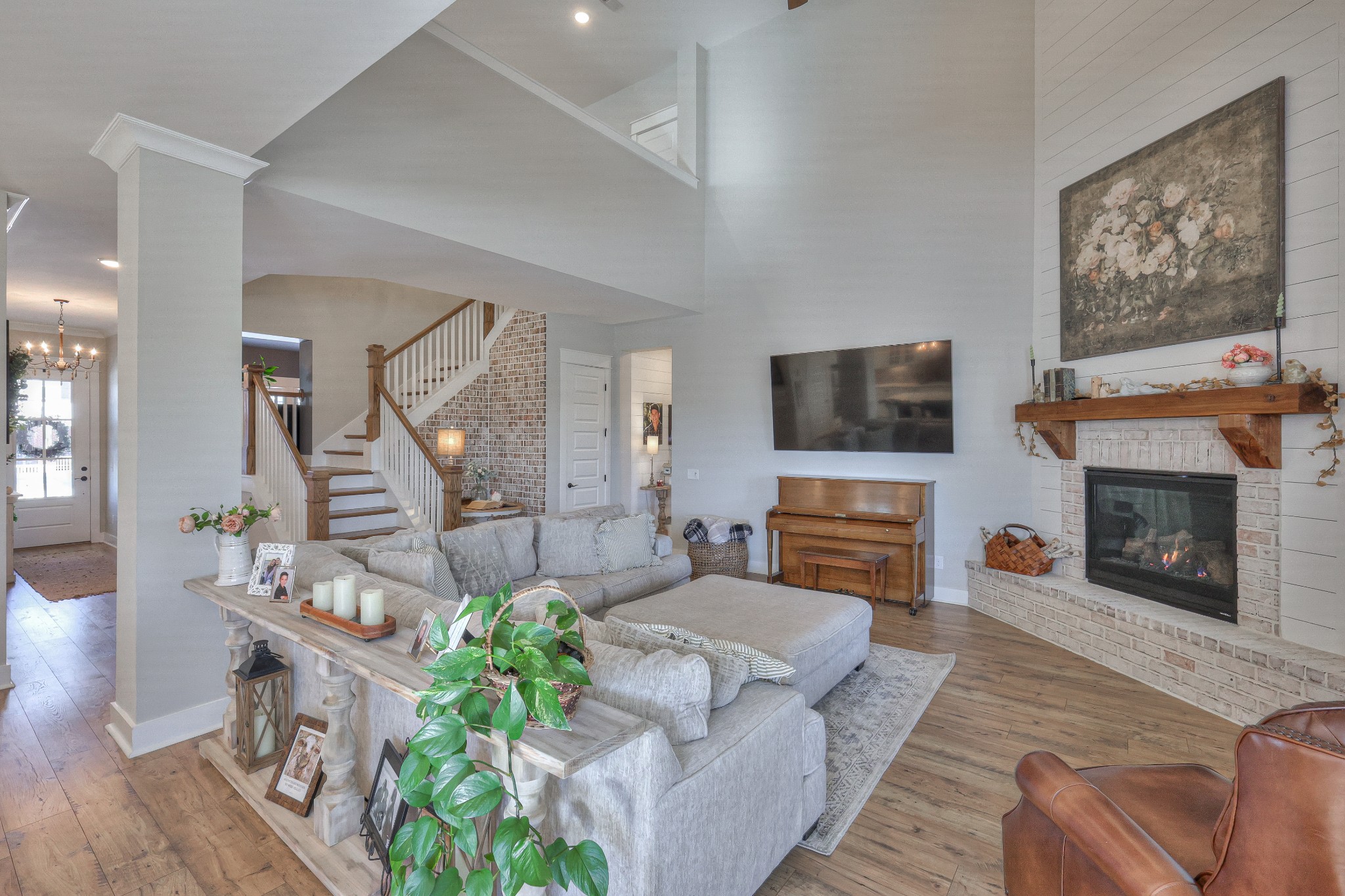 7760 Thayer Road Nolensville, TN 37135 - Photo 18 of 58 a living room with furniture a flat screen tv and a fireplace