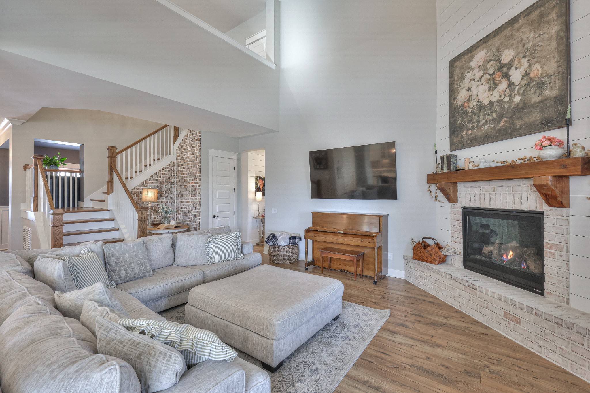 7760 Thayer Road Nolensville, TN 37135 - Photo 19 of 58 a living room with furniture a flat screen tv and a fireplace