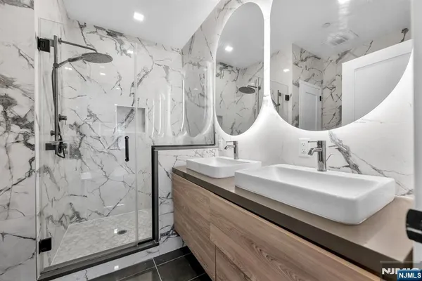 a close view of light fixtures and utility room with two mirror