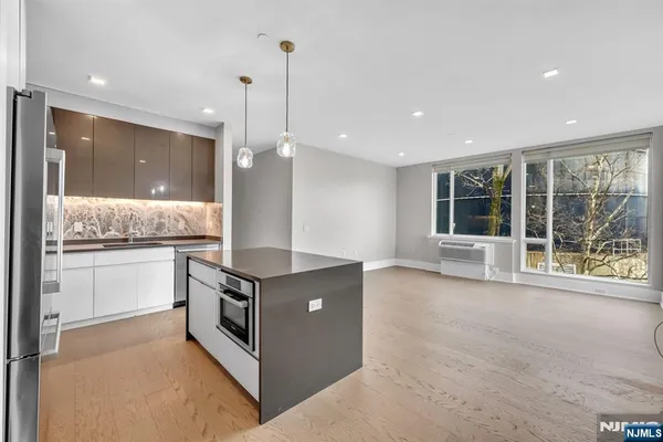 a kitchen with stainless steel appliances granite countertop a stove and a sink