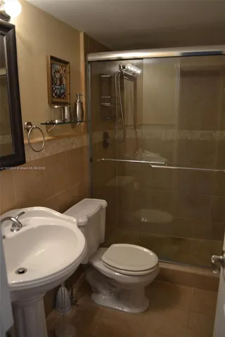 a white toilet sitting next to a bathroom sink