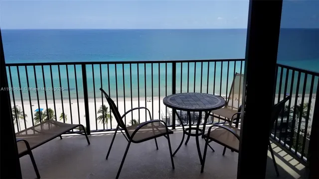 a view of a chairs and table in the balcony