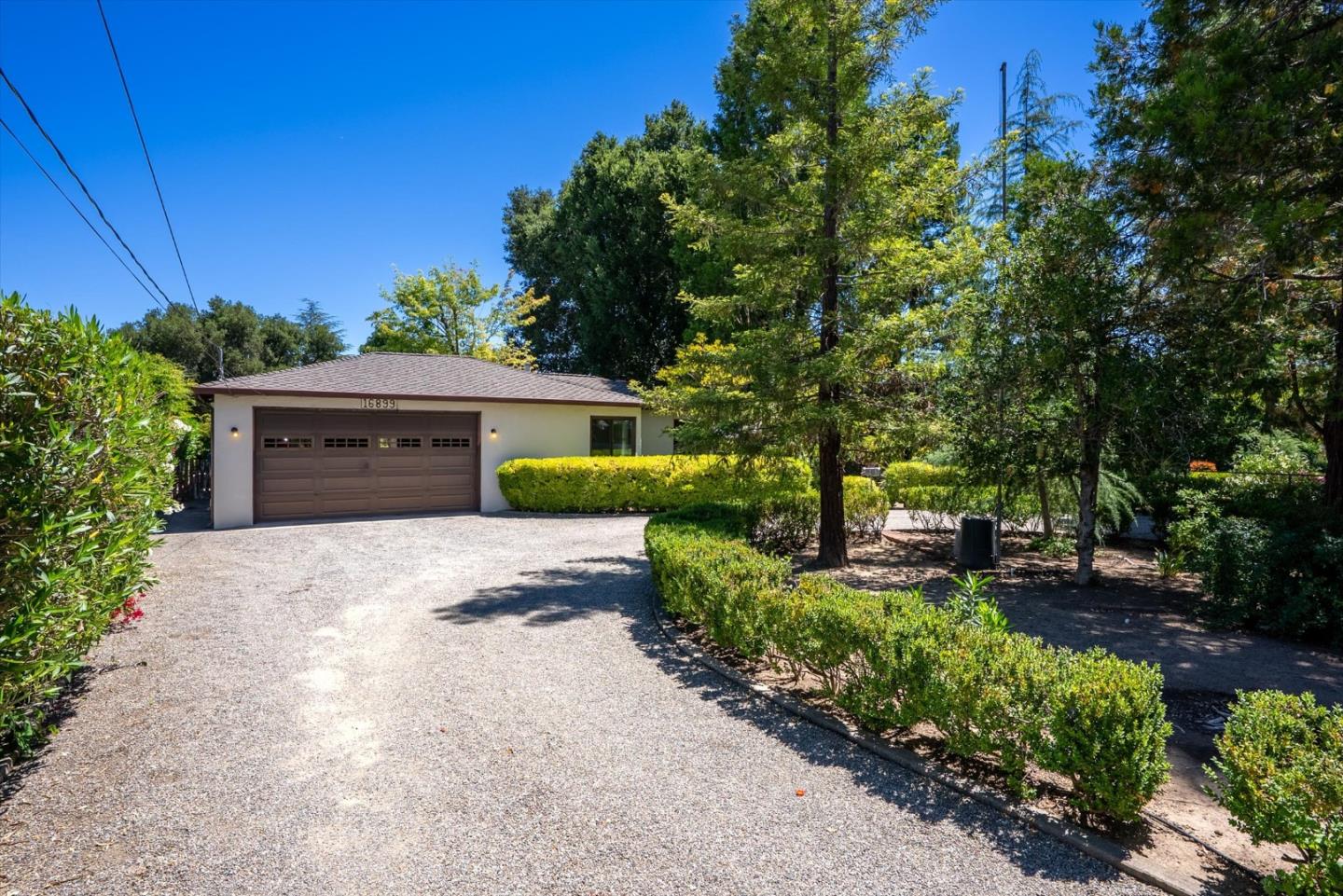 16899 Kennedy Road Los Gatos, CA 95032 - Photo 21 of 61 a front view of a house with a garden and trees