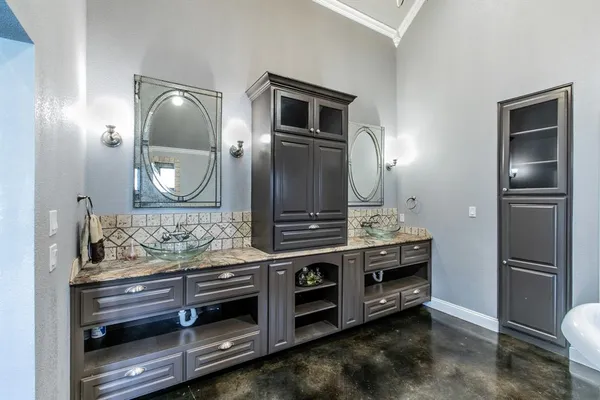 a kitchen with stainless steel appliances kitchen island granite countertop a stove a refrigerator and cabinets