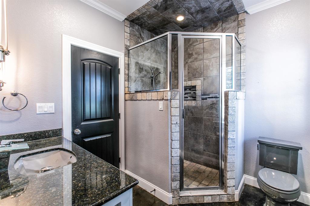 20 Independence Trail Waco, TX 76708 - Photo 17 of 40 a bathroom with a granite countertop sink a toilet and shower