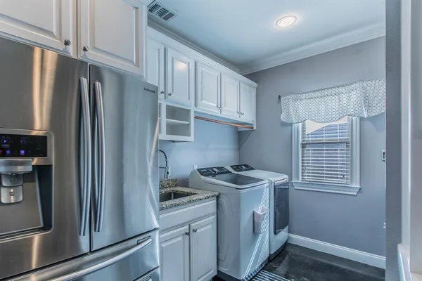 a kitchen with stainless steel appliances granite countertop a refrigerator a sink and a stove