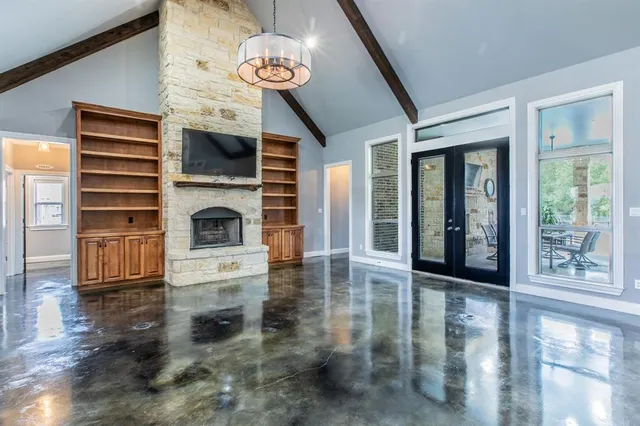 a view of a livingroom with an entryway and fireplace