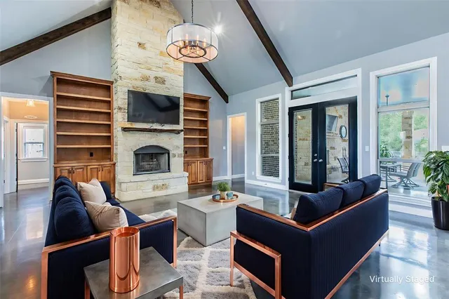 a living room with fireplace furniture and a large window