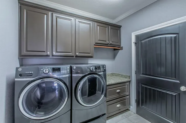 a utility room with sink dryer and washer