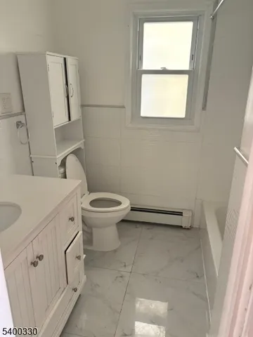 a bathroom with a toilet sink and window