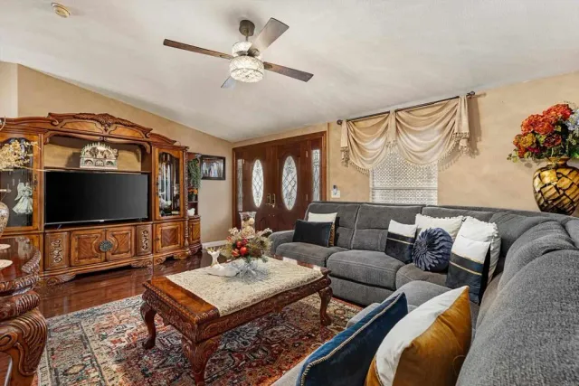 a kitchen with stainless steel appliances granite countertop a sink stove refrigerator and cabinets