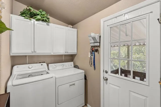a bedroom with a bed a large mirror and a flat tv screen on dresser