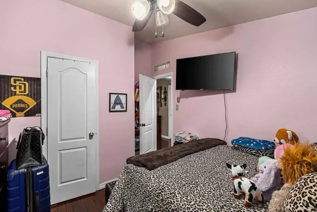 a view of a pathway of a house with wooden fence