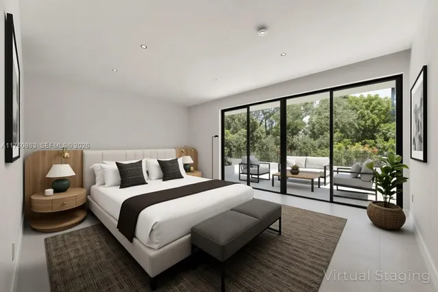 a bedroom with a bed a couch and a large window