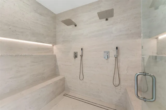 a bathroom with a bath tub with a shower