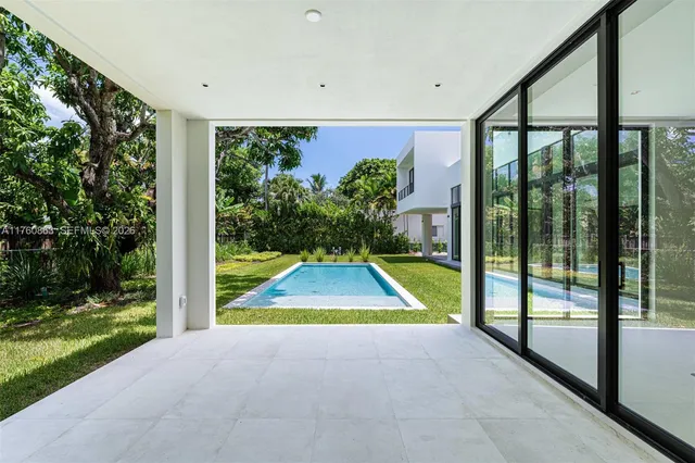 a living room with furniture and a floor to ceiling window