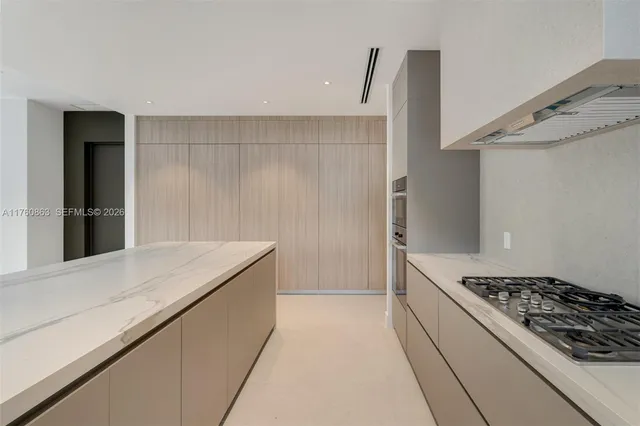 a kitchen with a stove and a refrigerator