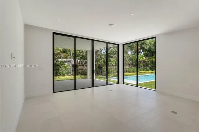 a view of an empty room with window and an empty room