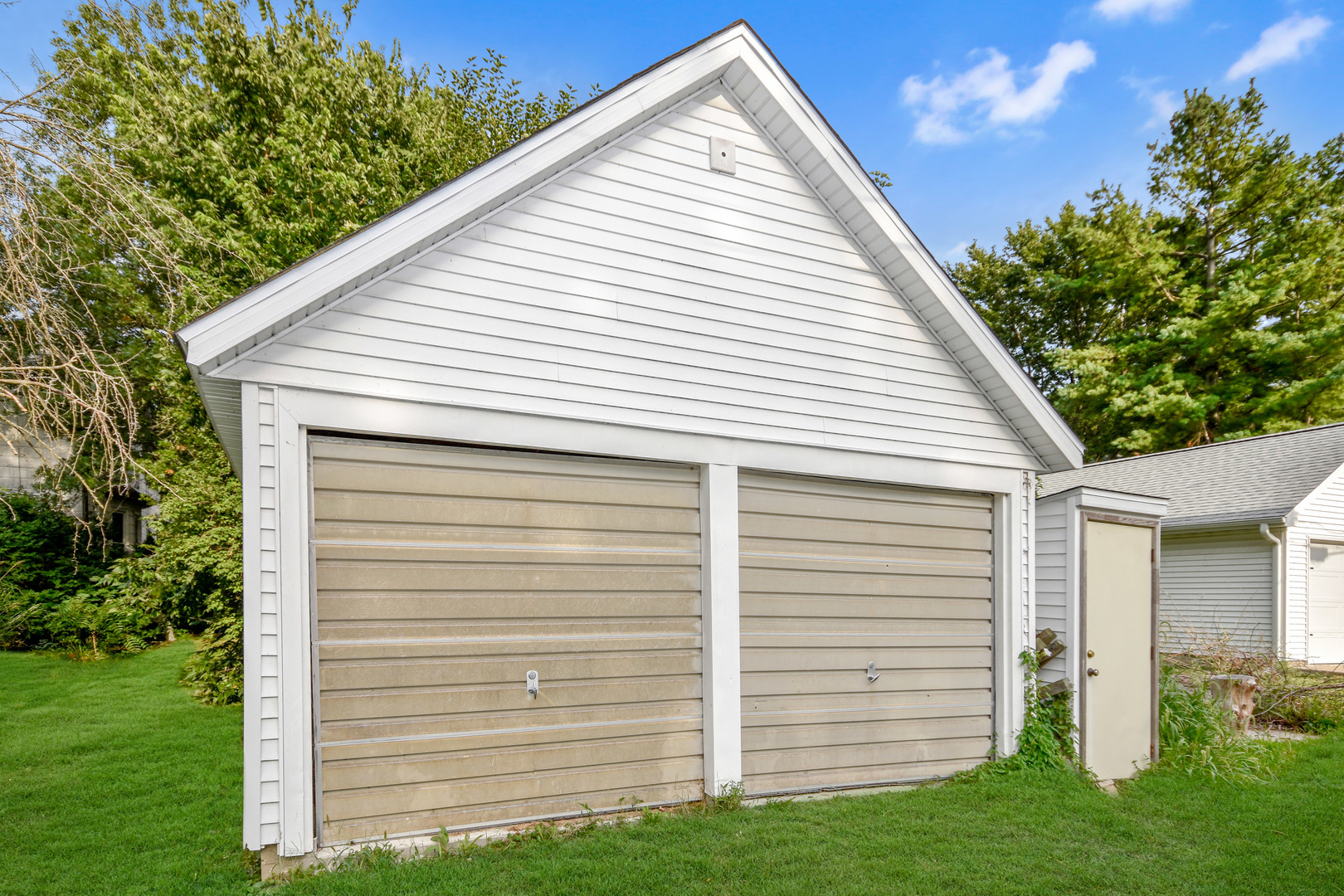 413 North 3rd Street Dunlap, IL 61525 - Photo 41 of 41 a view of a white house with a small yard and a large tree