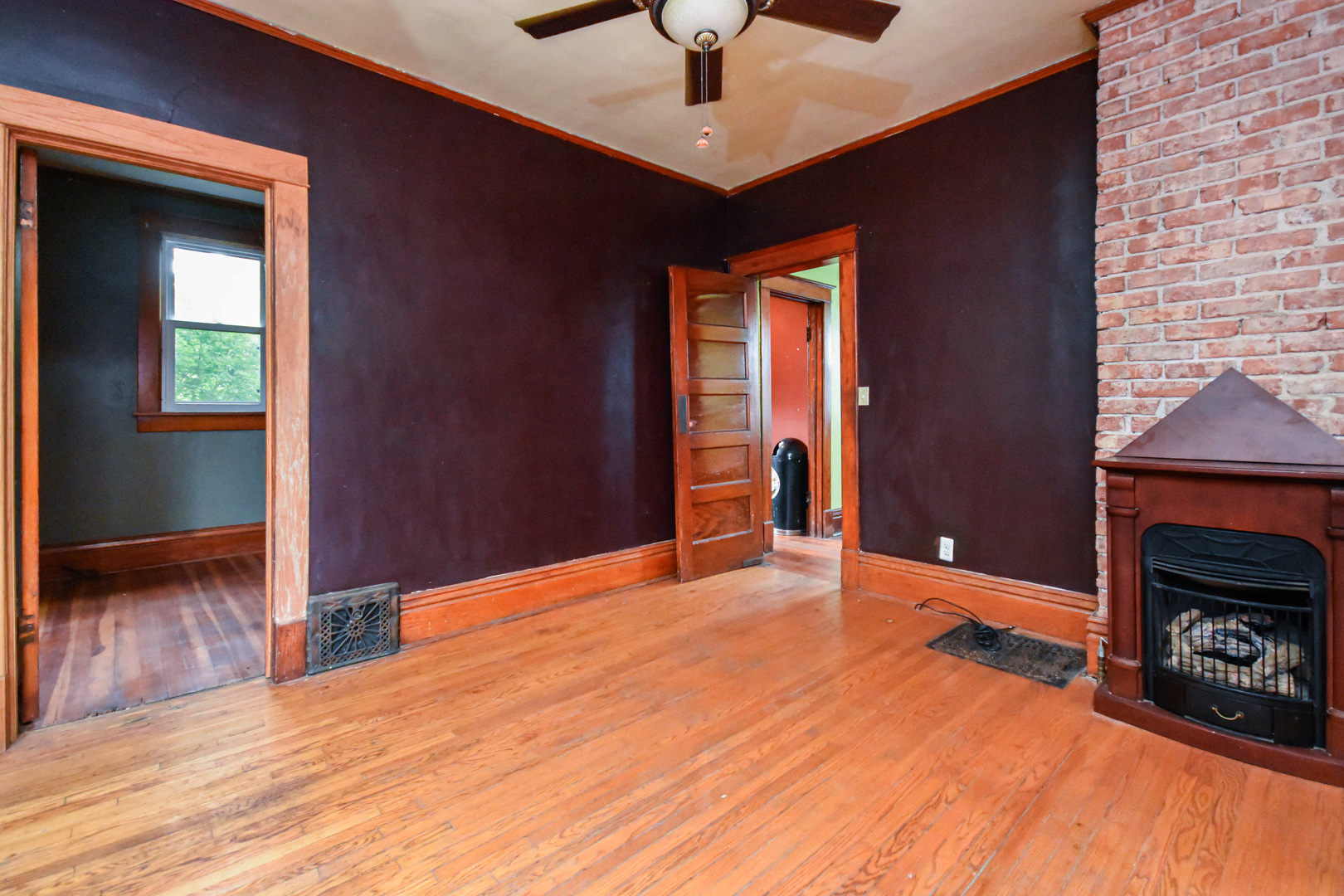 413 North 3rd Street Dunlap, IL 61525 - Photo 10 of 41 a view of an empty room with wooden floor and a fireplace