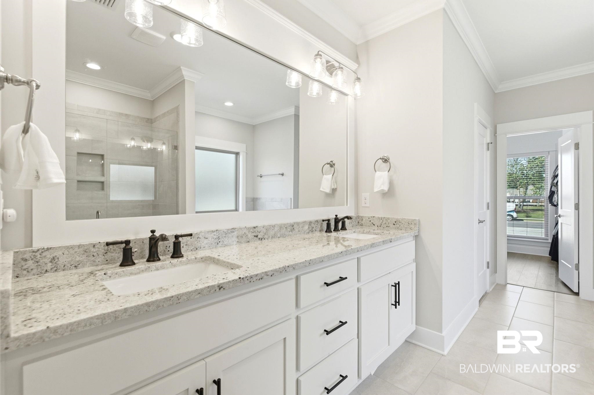 12132 Exbury Way Daphne, AL 36527 - Photo 16 of 47 Full bath featuring double vanity, a stall shower, crown molding, and light tile patterned floors