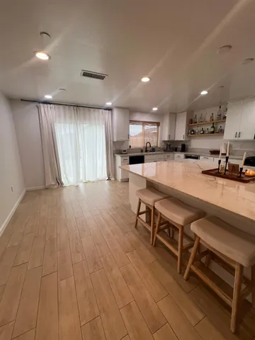 a kitchen with stainless steel appliances a stove a sink a refrigerator and cabinets