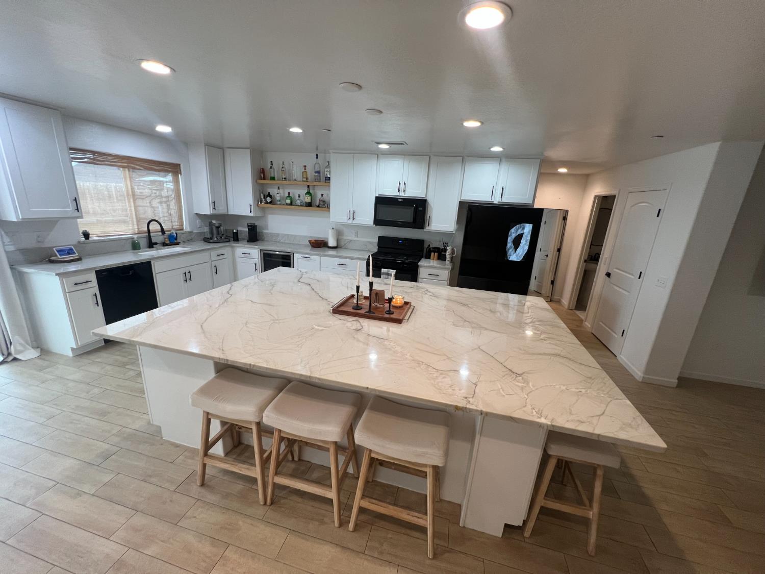 788 Apple Street Dinuba, CA 93618 - Photo 12 of 46 a kitchen with a dining table chairs and refrigerator