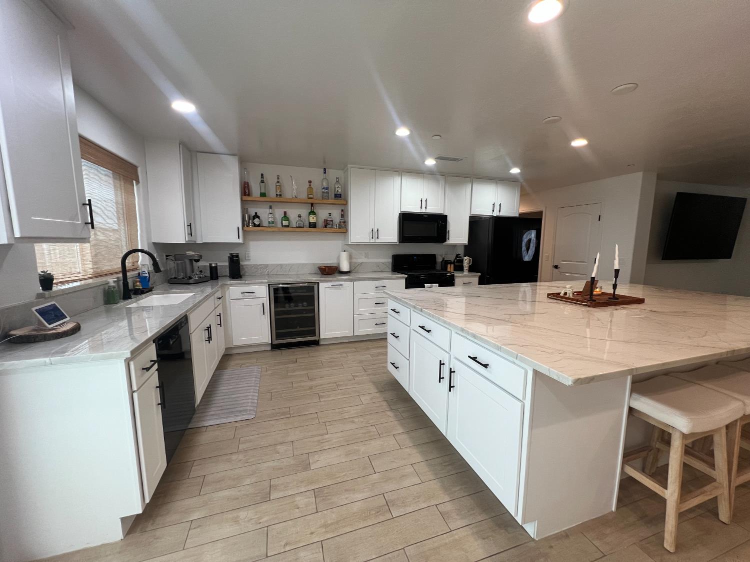 788 Apple Street Dinuba, CA 93618 - Photo 16 of 46 a large kitchen with stainless steel appliances lots of counter space and wooden floor