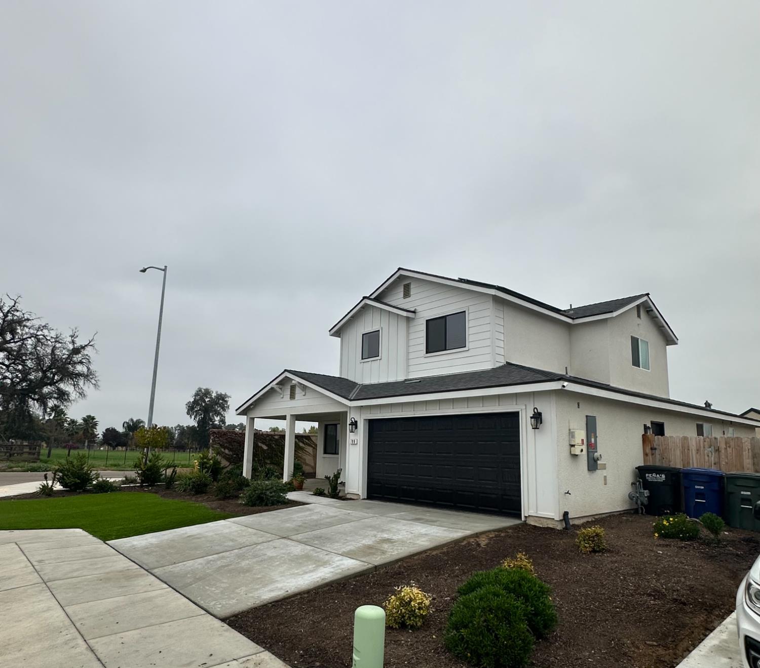 788 Apple Street Dinuba, CA 93618 - Photo 2 of 46 a front view of a house with a yard and garage