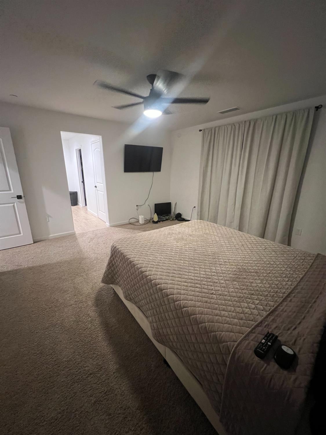 788 Apple Street Dinuba, CA 93618 - Photo 27 of 46 a large bed in a white room with a mirror