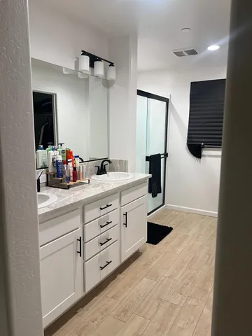 a bathroom with a sink double vanity and a mirror