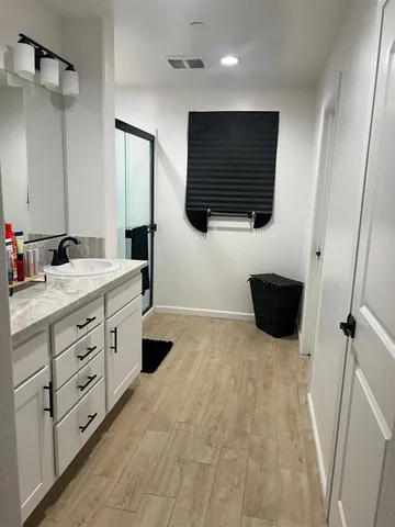 a bathroom with a double vanity sink and mirror