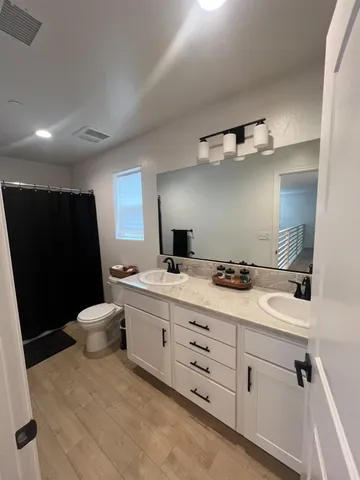 a view of a livingroom with kitchen and an empty space