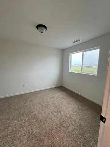 a view of an empty room and a window