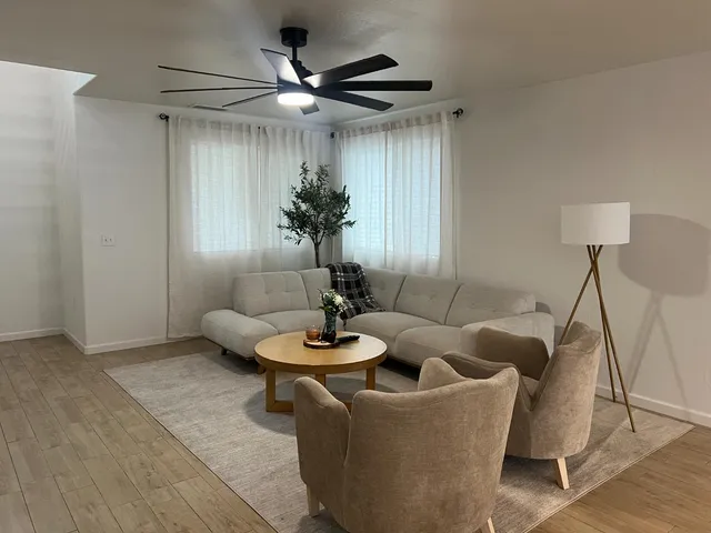 a living room with furniture and a large window