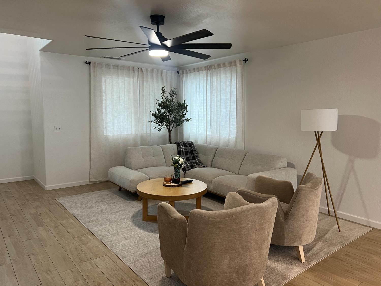 788 Apple Street Dinuba, CA 93618 - Photo 8 of 46 a living room with furniture and a large window
