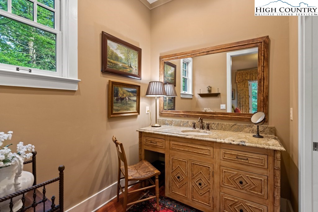 210 Farm Loop Road Banner Elk, NC 28604 - Photo 11 of 48 a bathroom with a granite countertop sink a mirror and a window