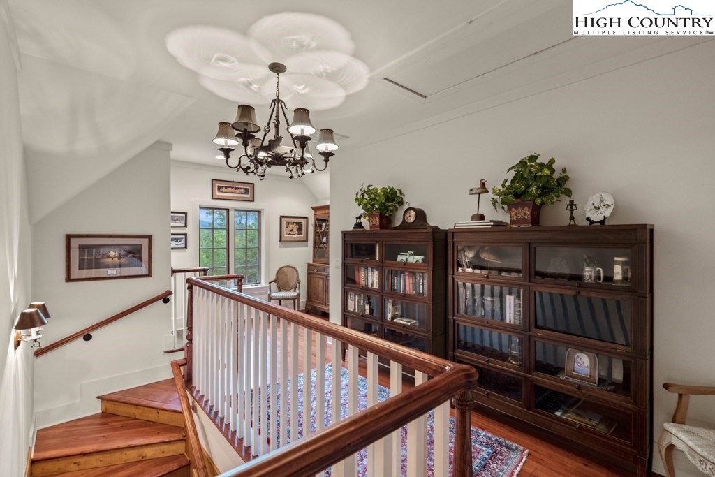 210 Farm Loop Road Banner Elk, NC 28604 - Photo 13 of 48 a view of a chandelier and wooden floor in a balcony