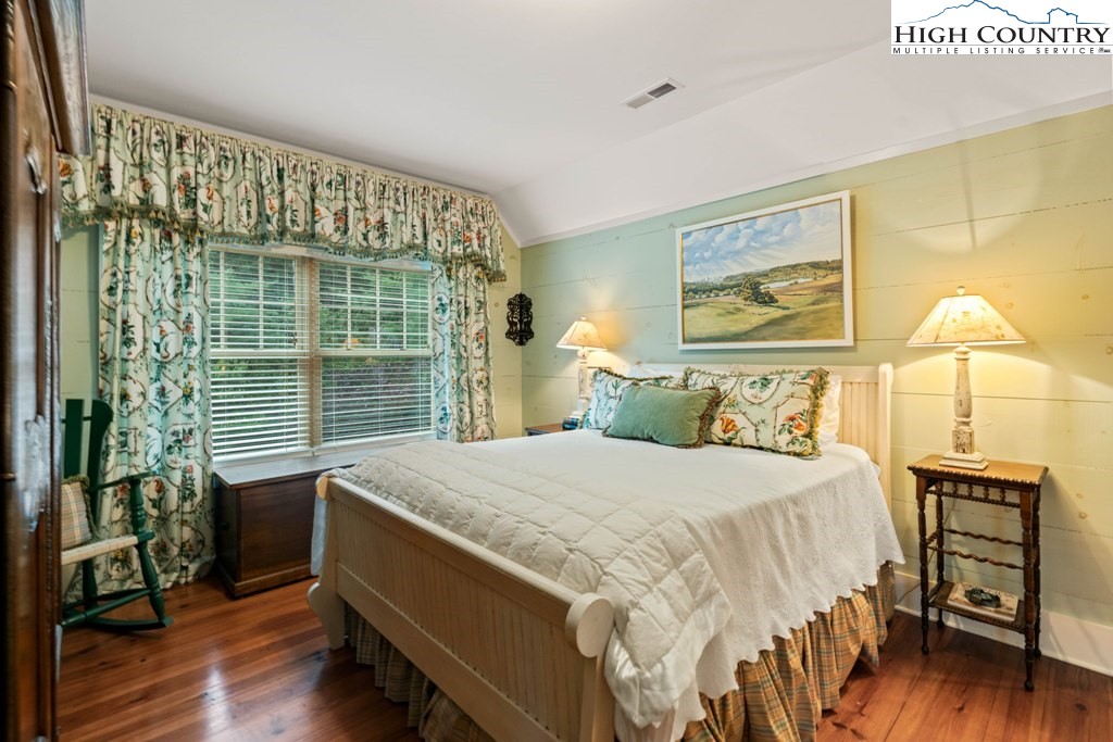 210 Farm Loop Road Banner Elk, NC 28604 - Photo 15 of 48 a bedroom with a bed and wooden floor
