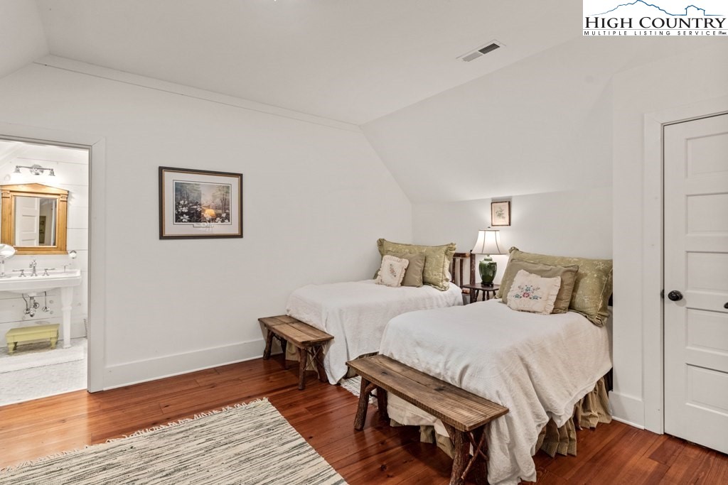 210 Farm Loop Road Banner Elk, NC 28604 - Photo 17 of 48 a bedroom with two beds and wooden floor