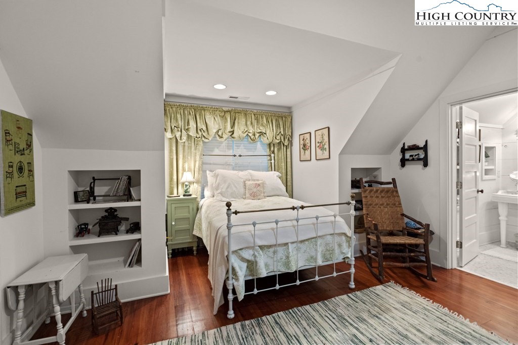 210 Farm Loop Road Banner Elk, NC 28604 - Photo 18 of 48 a bedroom with a bed and wooden floor