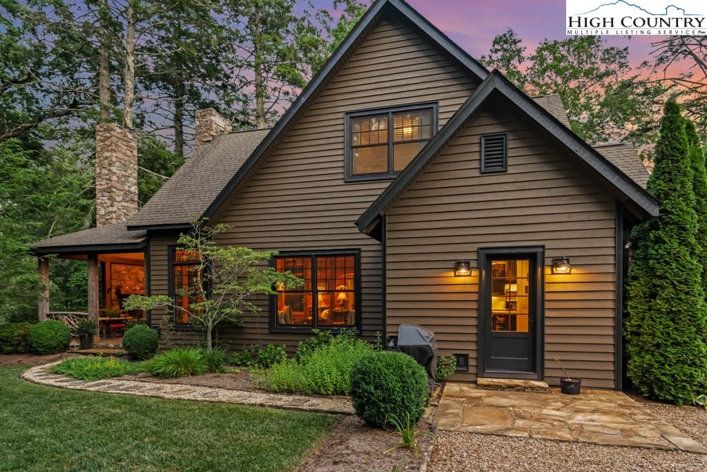 210 Farm Loop Road Banner Elk, NC 28604 - Photo 2 of 48 a front view of a house with a garden