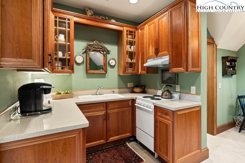 210 Farm Loop Road Banner Elk, NC 28604 - Photo 21 of 48 a kitchen with a sink a stove and a refrigerator