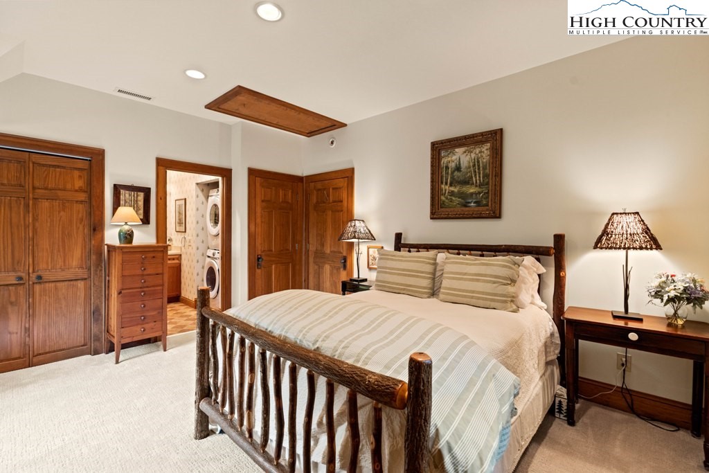 210 Farm Loop Road Banner Elk, NC 28604 - Photo 22 of 48 a bedroom with a bed and a dresser