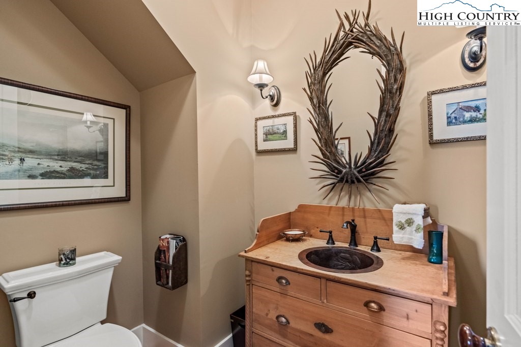 210 Farm Loop Road Banner Elk, NC 28604 - Photo 29 of 48 a bathroom with a toilet sink and mirror