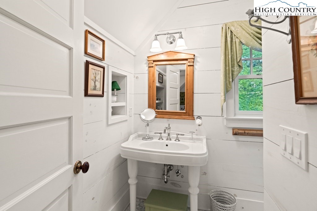 210 Farm Loop Road Banner Elk, NC 28604 - Photo 36 of 48 a bathroom with a sink a mirror and a shower